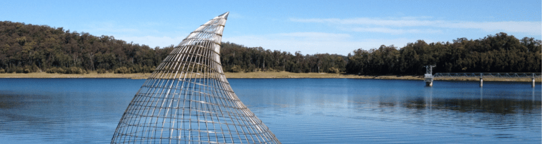 View across Cowarra dam with raindrop sculpture in the foreground.