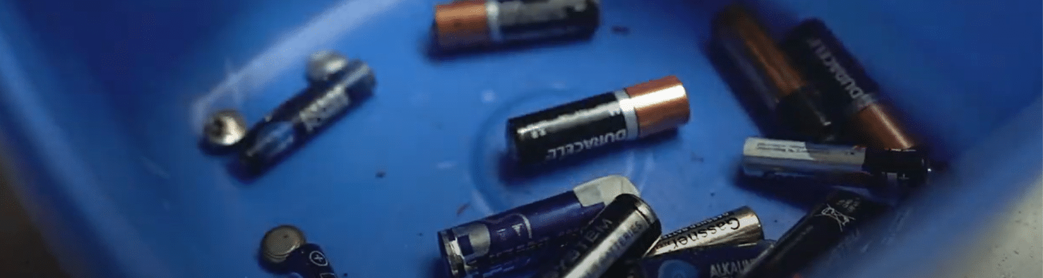 close up of household batteries inside a container